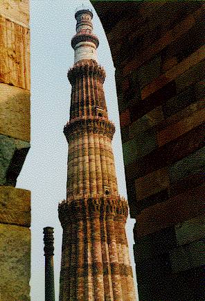[The Qutab Minar with the iron pillar to its left]